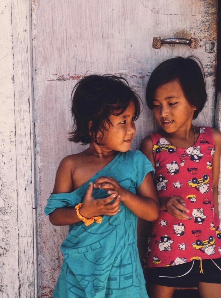 two homeless girls talking in Philippines